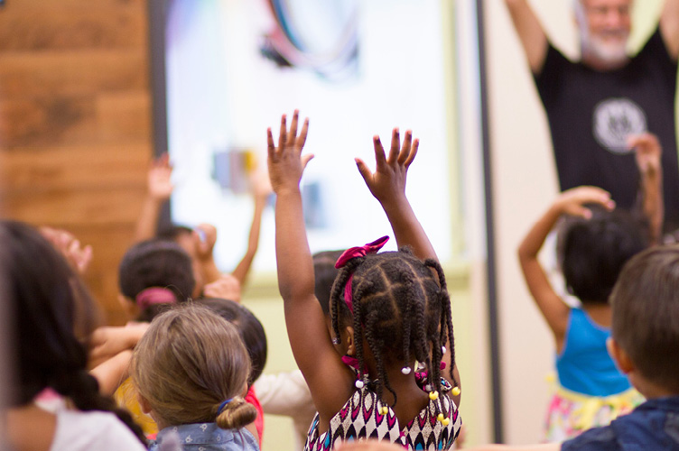 Child with hands raised