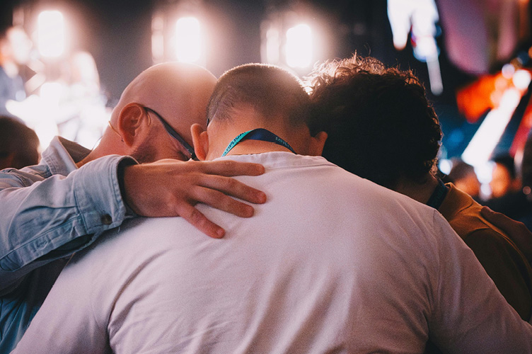 Group praying over one another