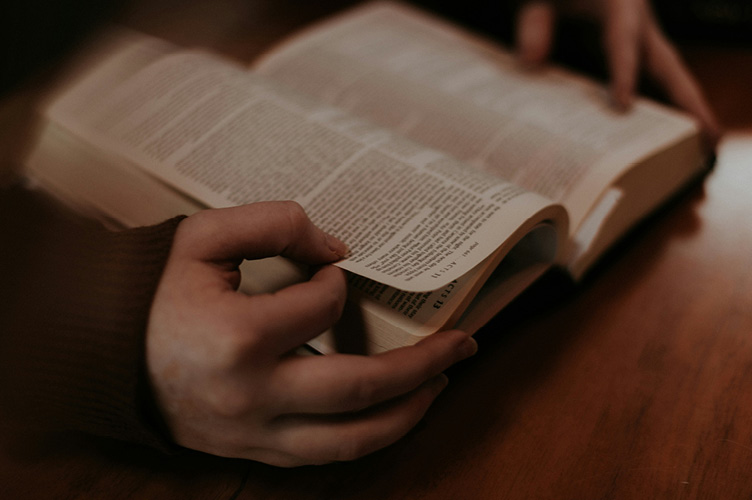 Person holding open Bible