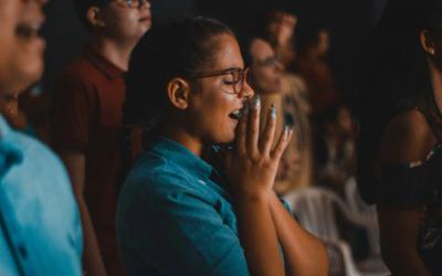 Girl with hands together in praise