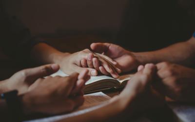 Holding hands in prayer