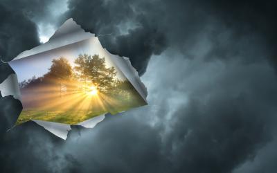 Clouds peeling back to reveal sunny landscape