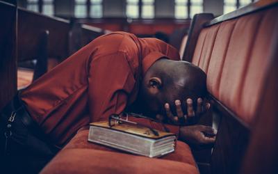 Person kneeling in prayer