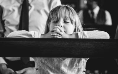 Child praying in church