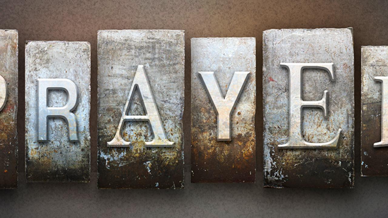 "prayer" spelled out in metal type
