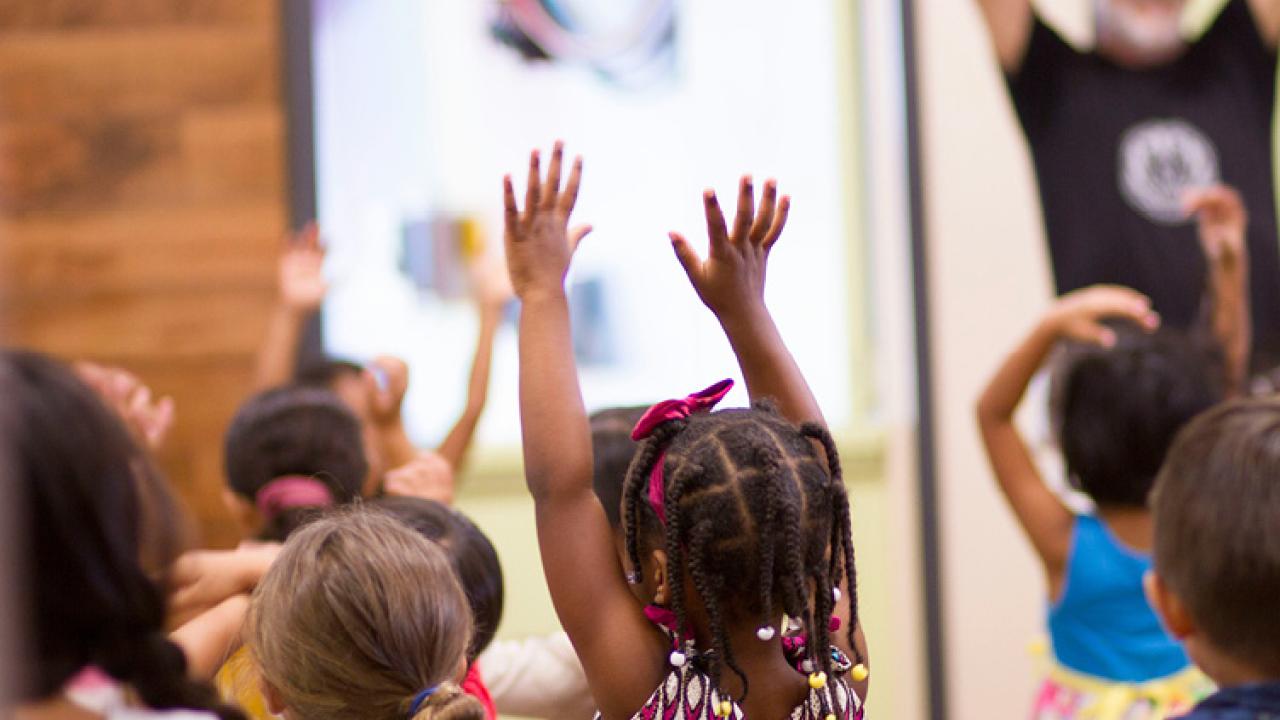 Child with hands raised