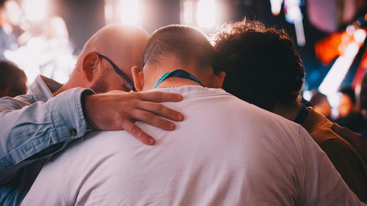 Group praying over one another