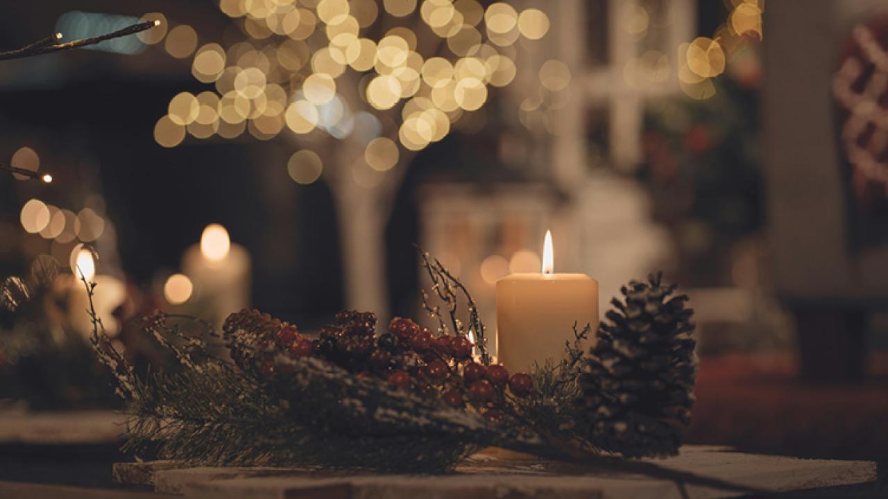 Christmas scene with candle and a pinecone