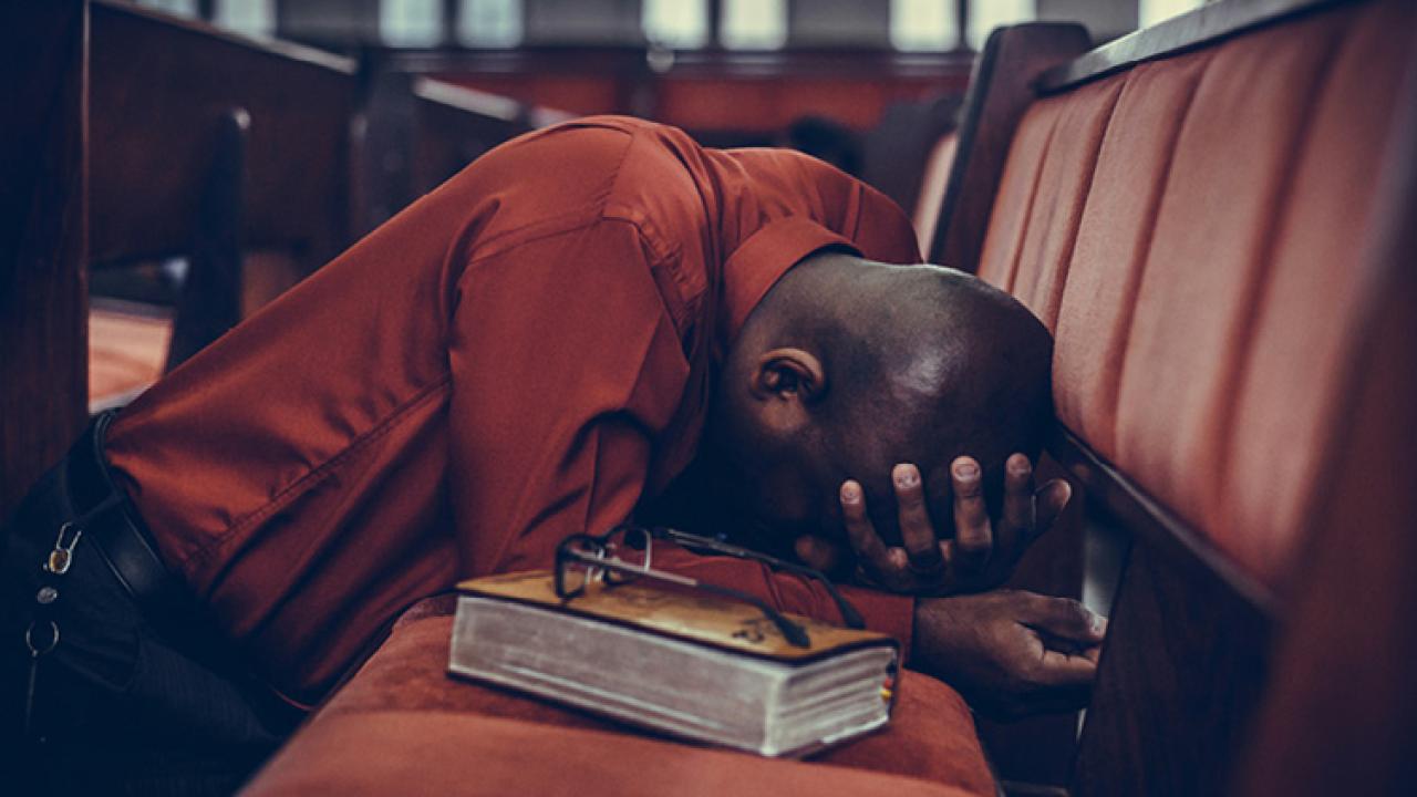 Person kneeling in prayer