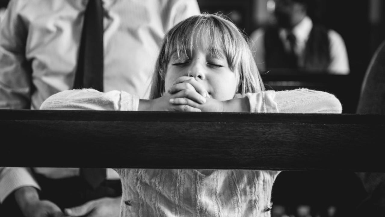Child praying in church