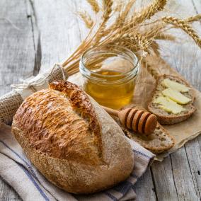 Bundle of weat, loaf of bread, honey jar