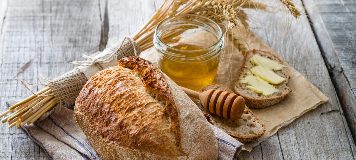 Bundle of weat, loaf of bread, honey jar
