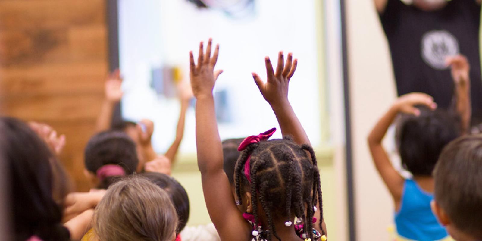 Child with hands raised