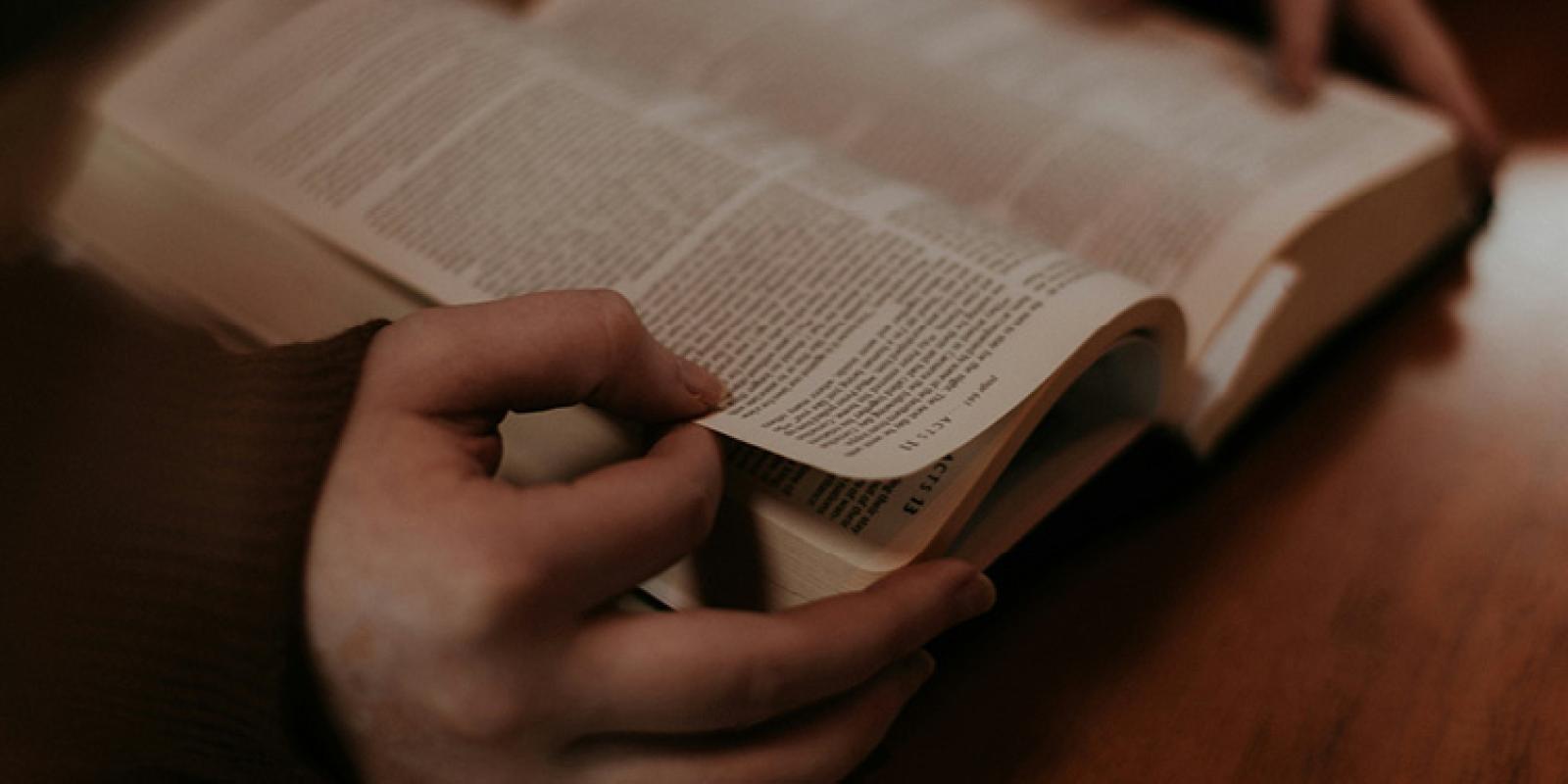Person holding open Bible