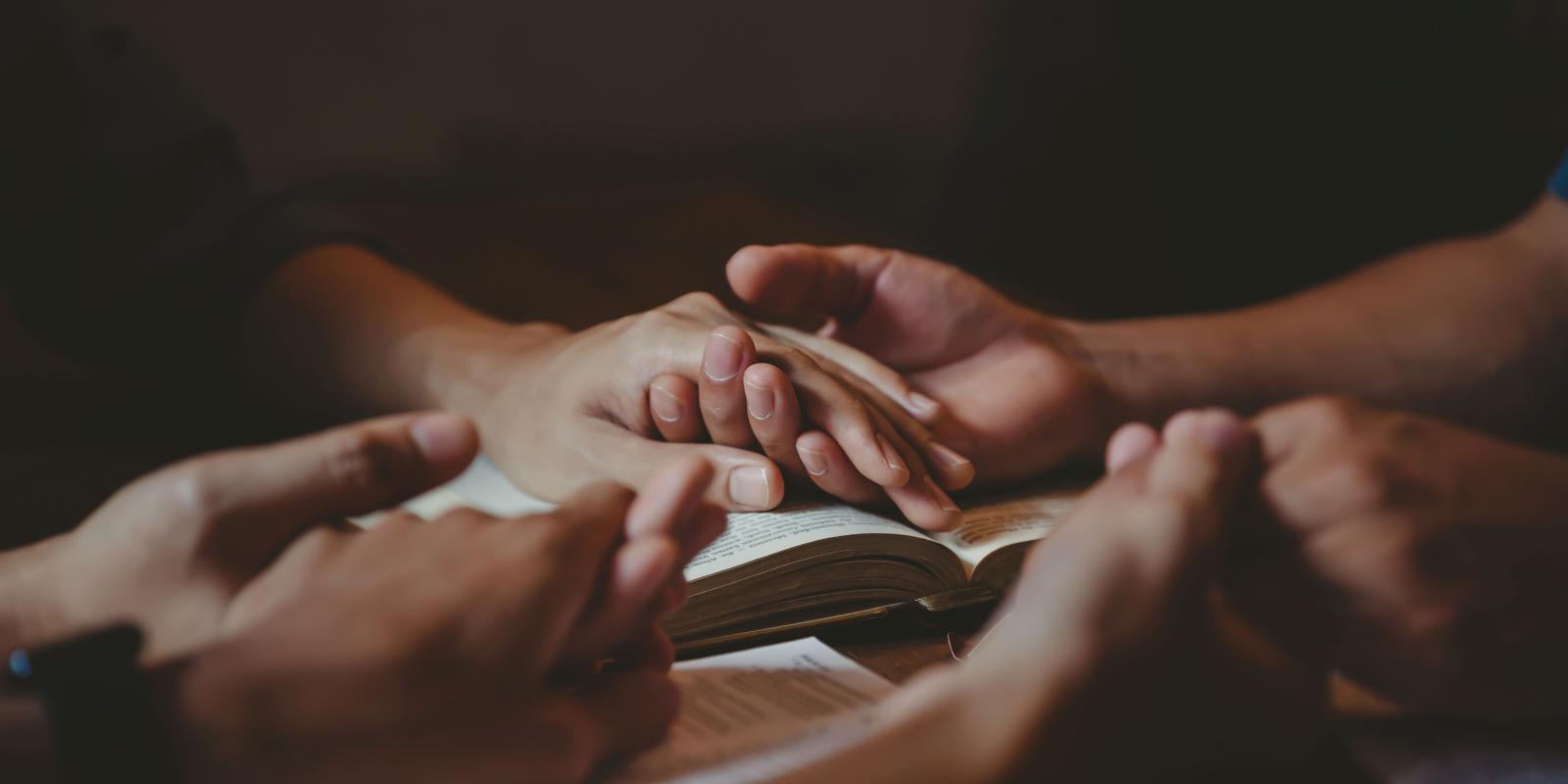 Holding hands in prayer
