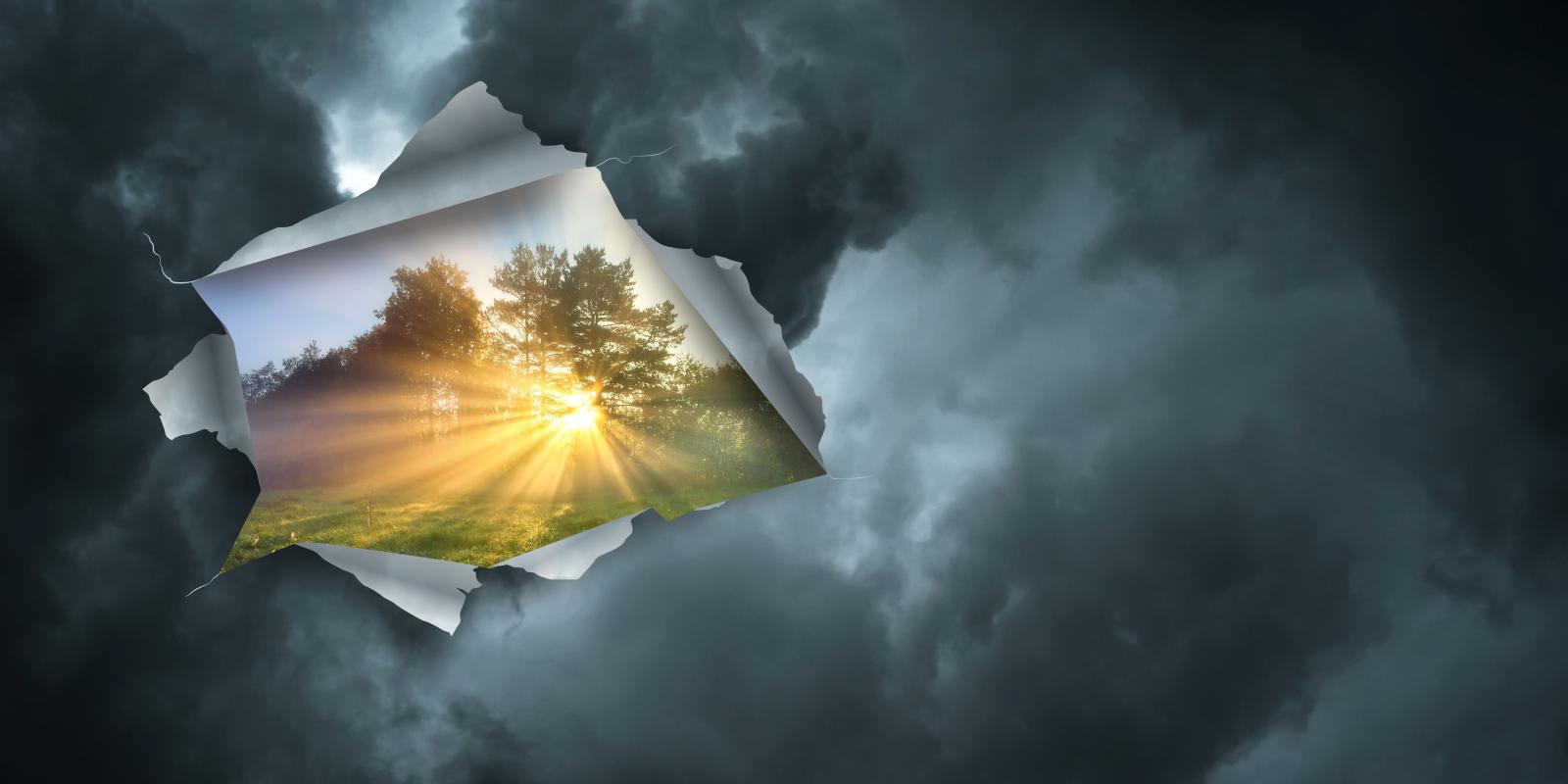 Clouds peeling back to reveal sunny landscape